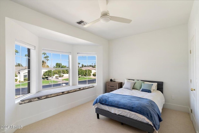 bedroom with carpet flooring, multiple windows, and ceiling fan