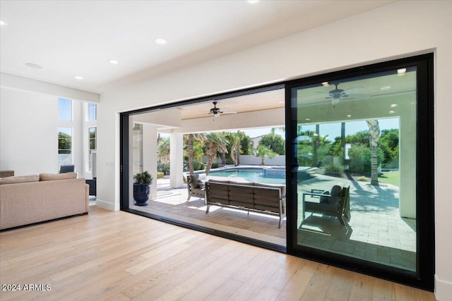 doorway to outside with light hardwood / wood-style flooring and a wealth of natural light