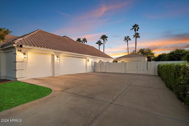 property exterior at dusk with a garage