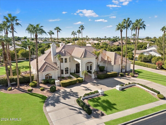 mediterranean / spanish house with a front yard