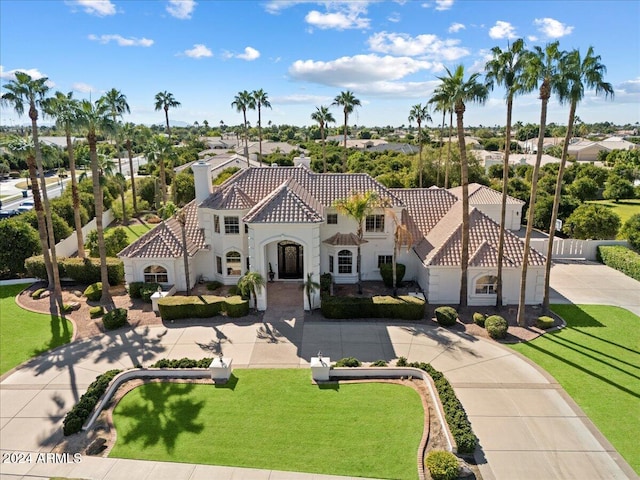 mediterranean / spanish-style house featuring a front lawn