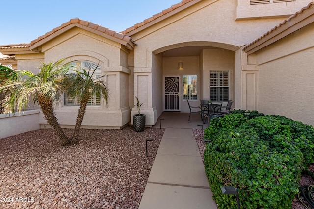 doorway to property with a patio