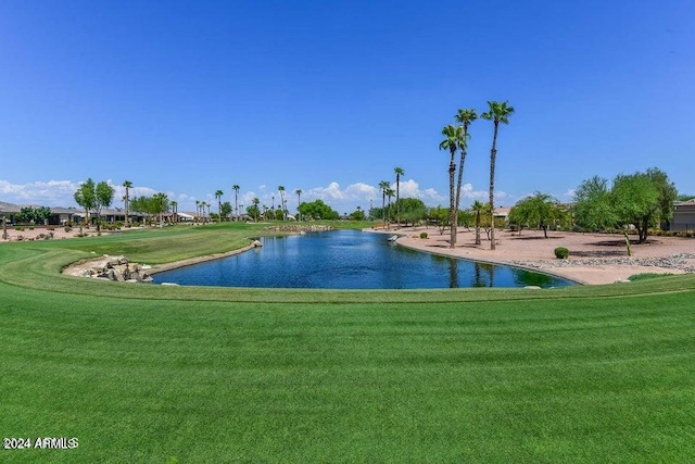 view of home's community with a yard and a water view