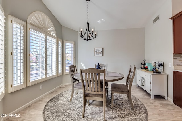 dining room with an inviting chandelier and light hardwood / wood-style floors