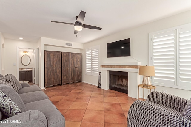 living room with ceiling fan, light tile patterned flooring, and sink