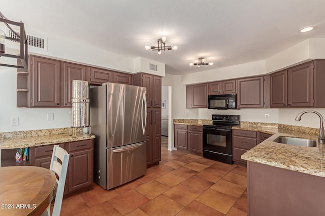 kitchen featuring a notable chandelier, black appliances, sink, light stone countertops, and dark brown cabinets