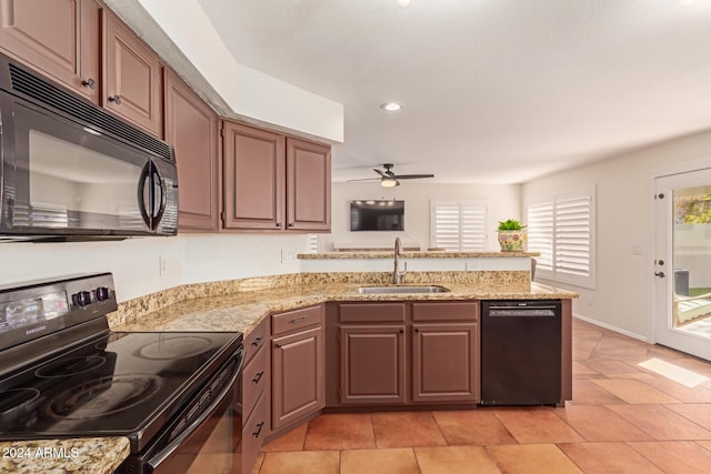 kitchen featuring black appliances, ceiling fan, light stone counters, and sink