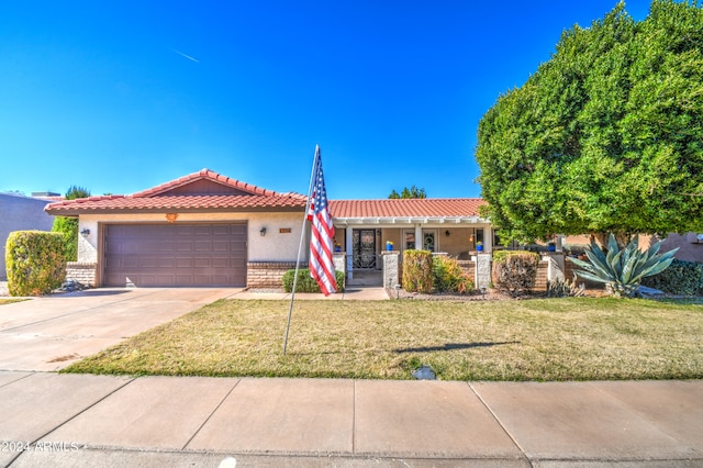 view of front of house featuring a garage and a front yard