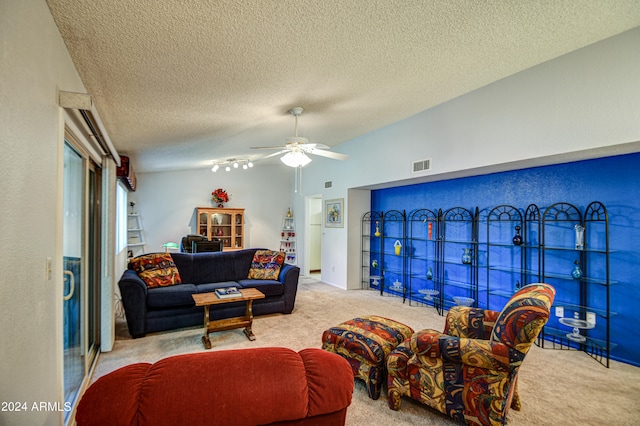 living room featuring light colored carpet, ceiling fan, and a textured ceiling