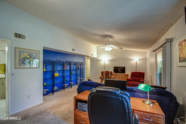 carpeted office with ceiling fan, a textured ceiling, and lofted ceiling