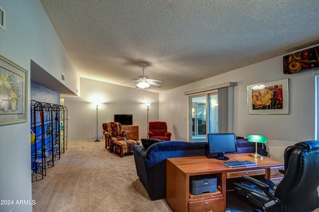 carpeted office featuring a textured ceiling and ceiling fan