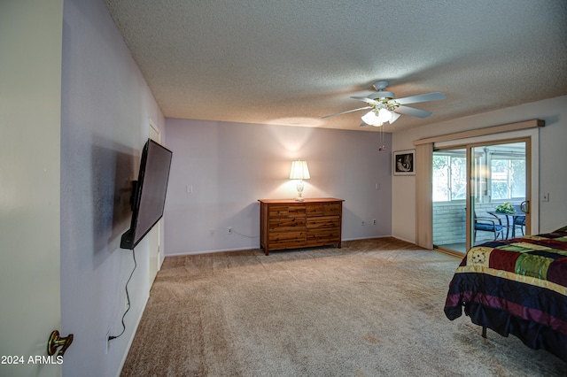 bedroom with light carpet, a textured ceiling, ceiling fan, and access to exterior