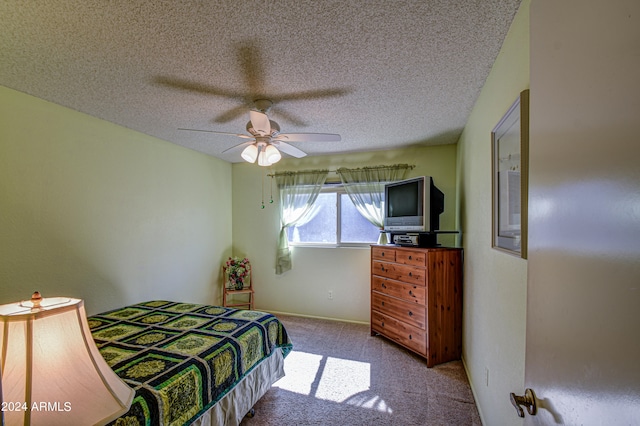 bedroom featuring carpet, ceiling fan, and a textured ceiling