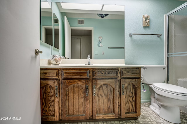 bathroom with tile flooring, large vanity, and toilet