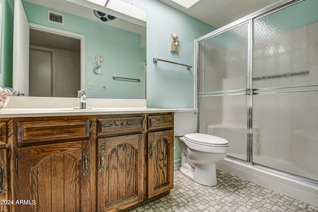 bathroom featuring walk in shower, tile flooring, vanity, and toilet