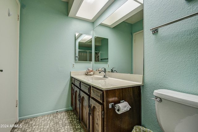 bathroom with tile floors, toilet, and vanity