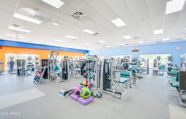 exercise room with a healthy amount of sunlight and a paneled ceiling