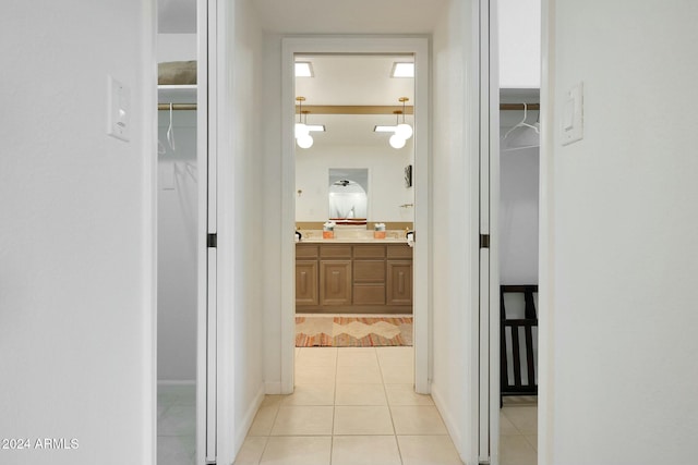 corridor featuring light tile patterned floors