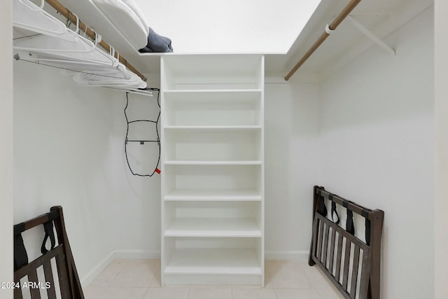 walk in closet featuring light tile patterned flooring