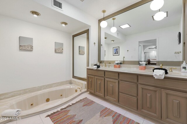 bathroom with vanity, tile patterned floors, and a tub