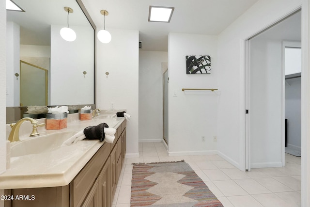 bathroom with tile patterned floors, vanity, and an enclosed shower