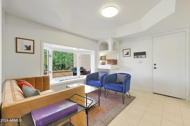 tiled living room featuring a tray ceiling