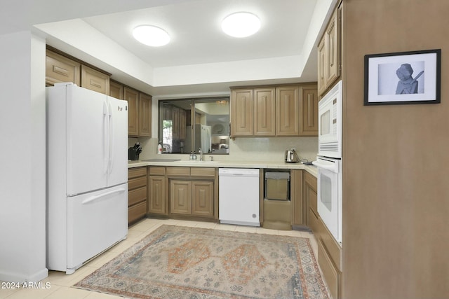 kitchen featuring backsplash, white appliances, sink, and light tile patterned floors