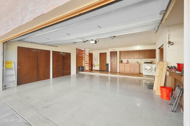 garage featuring separate washer and dryer and a garage door opener