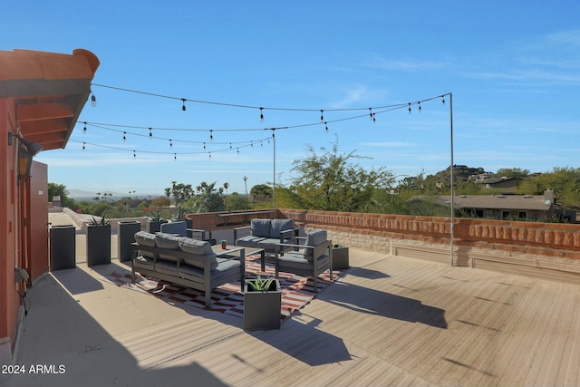 wooden terrace with an outdoor hangout area