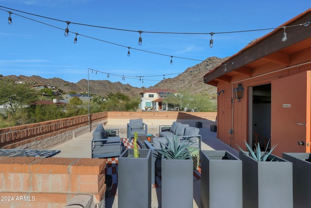 view of patio / terrace featuring a mountain view and an outdoor hangout area