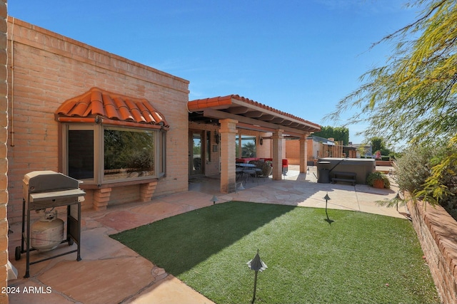 view of yard featuring a patio and a hot tub