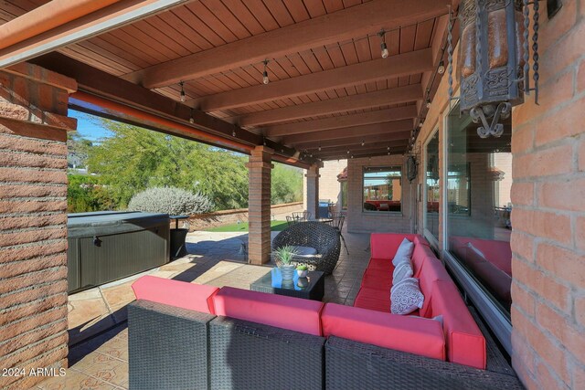 view of patio / terrace featuring an outdoor living space and a hot tub