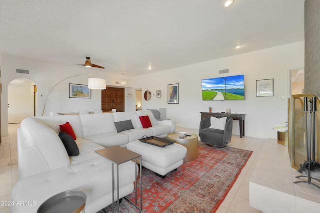 tiled living room with ceiling fan