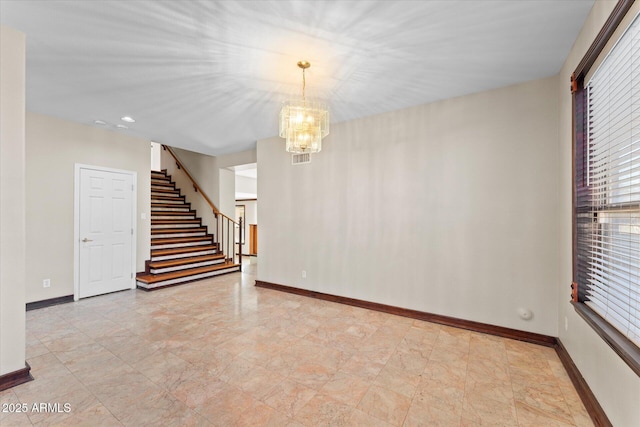 spare room with visible vents, stairs, baseboards, and a chandelier