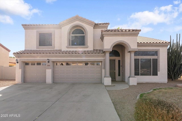 mediterranean / spanish-style house featuring a garage, driveway, a tiled roof, and stucco siding