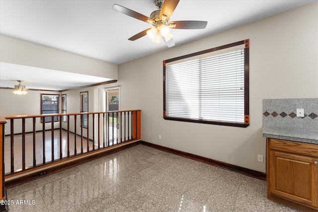 spare room featuring granite finish floor and baseboards