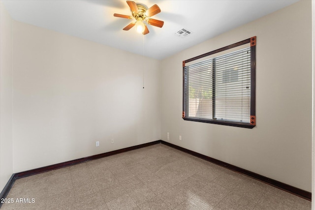 empty room with ceiling fan, visible vents, baseboards, and tile patterned floors