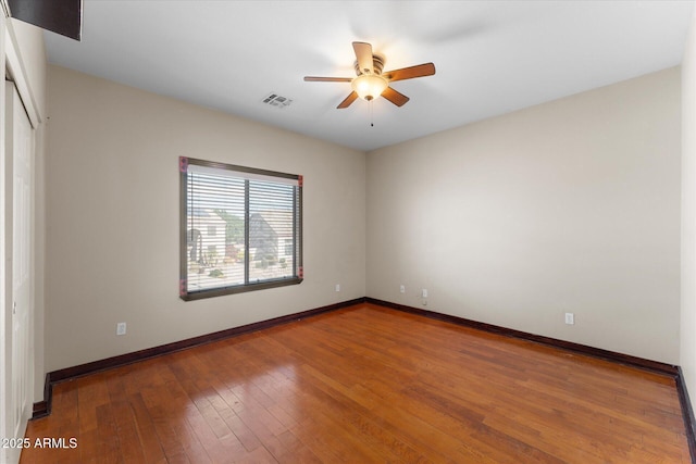 interior space featuring hardwood / wood-style flooring, baseboards, visible vents, and a closet