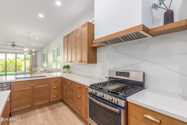 kitchen with backsplash, light hardwood / wood-style flooring, premium range hood, stainless steel gas stove, and sink