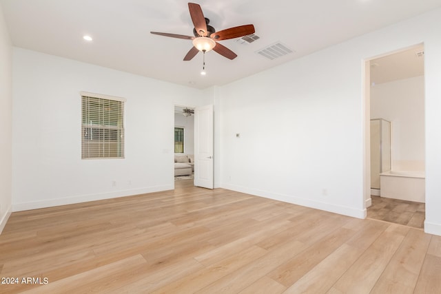 spare room with light wood-type flooring and ceiling fan