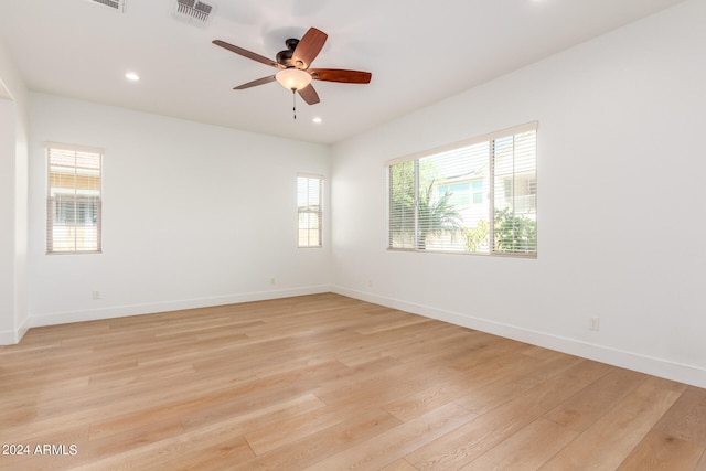 unfurnished room featuring a healthy amount of sunlight and light hardwood / wood-style floors