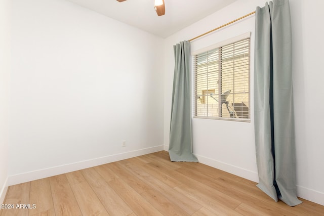 spare room with light wood-type flooring and ceiling fan