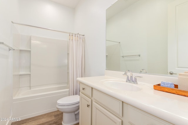 full bathroom with shower / bathtub combination with curtain, hardwood / wood-style flooring, vanity, and toilet