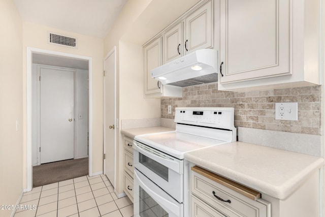 kitchen with light tile patterned floors and white stove