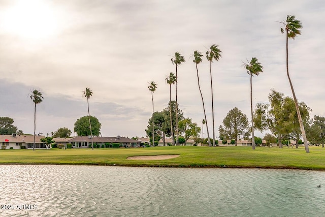 view of property's community with a yard and a water view