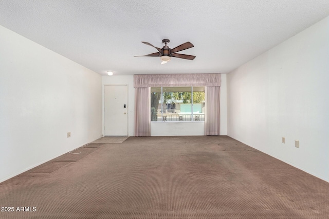 carpeted empty room with a textured ceiling and ceiling fan