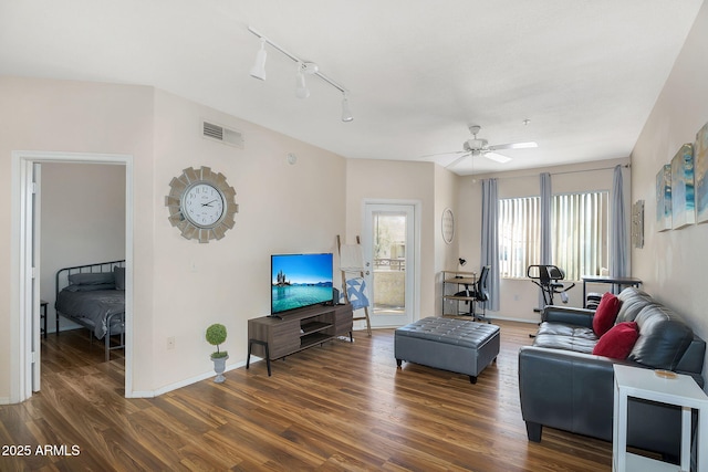 living area with visible vents, track lighting, wood finished floors, baseboards, and a ceiling fan