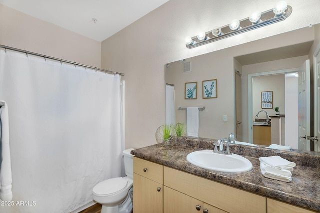 full bathroom featuring vanity, toilet, and visible vents