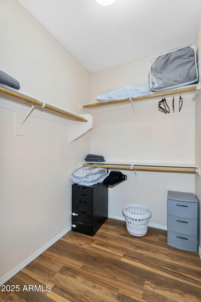 spacious closet with wood finished floors