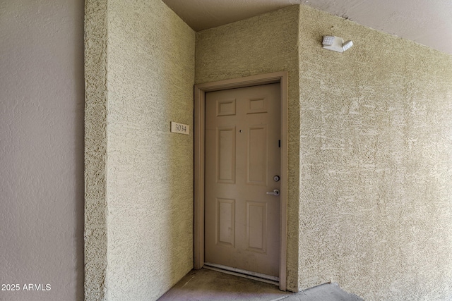 doorway to property with stucco siding